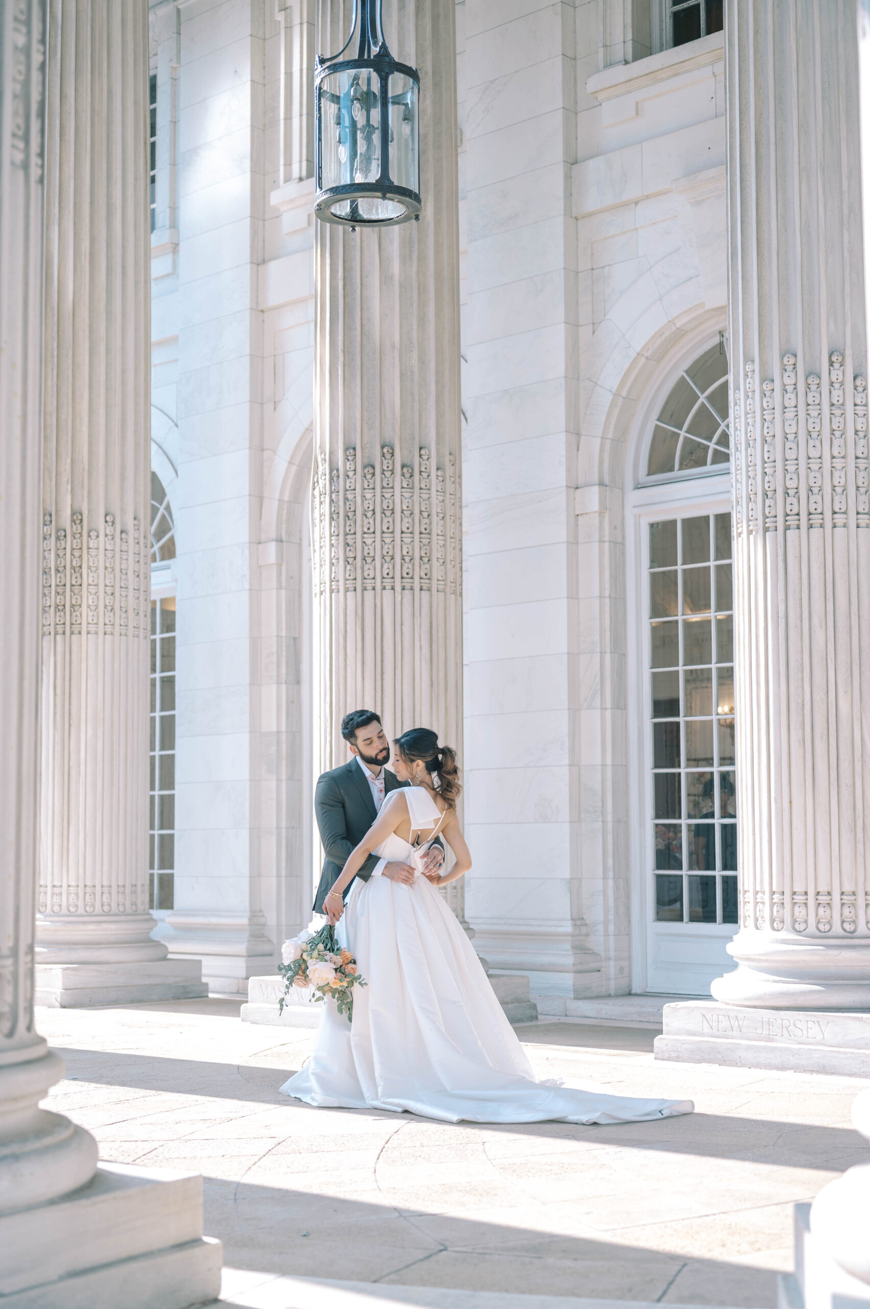 Bride and groom between the columns of the DAR