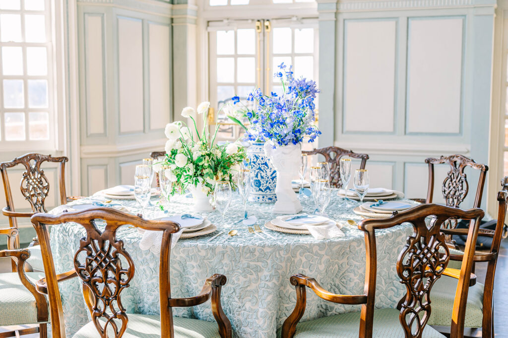 reception table set up with blue flowers